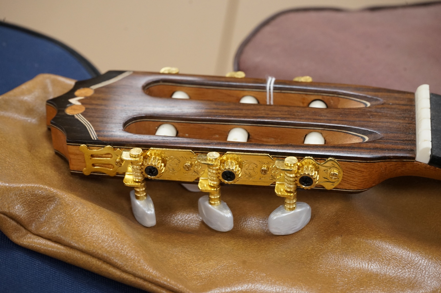 A handmade cedar, Indian Rosewood and ebony classical guitar by 'an English Luthier', with label to the inside of the body, together with a soft case.